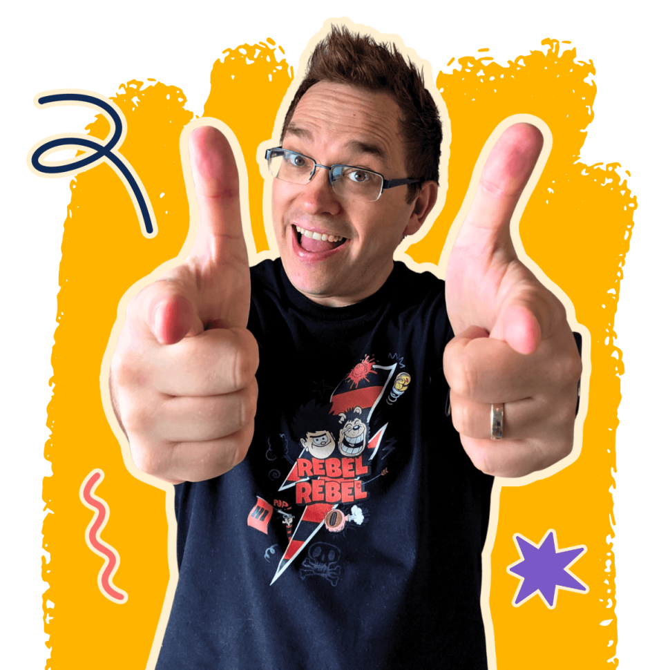 About Me Page Matt Drzymala from Indelible Think Copywriting Image (1) (1) Copywriter for playful brands, Matt Drzymala wearing a black Beano t shirt and pointing at the camera